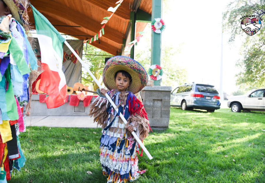 Young participant in traditional clothing at an Oaxaca en Utah community event