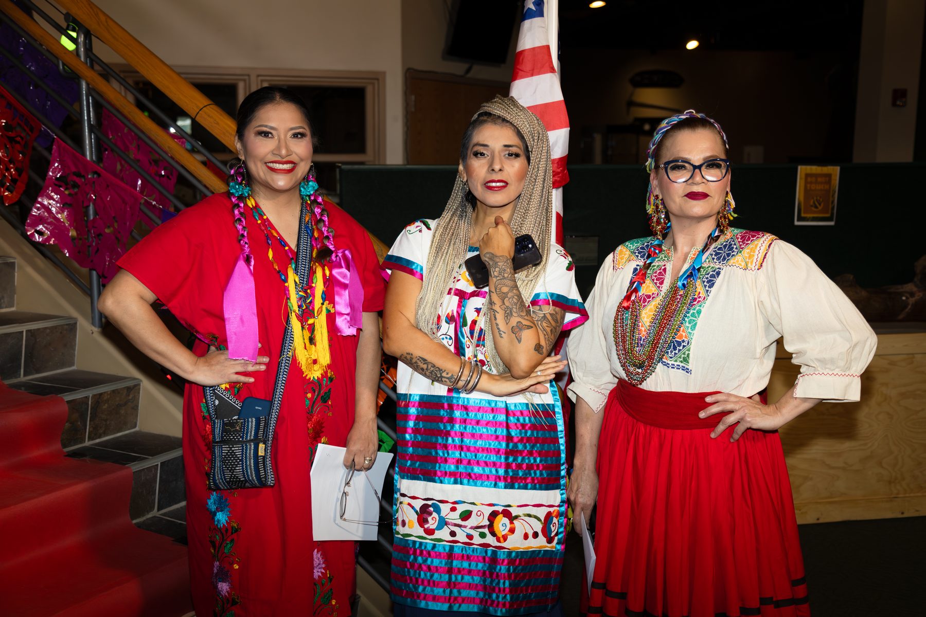Three Oaxaca en Utah participants in colorful garments at the 2026 Fashion Show